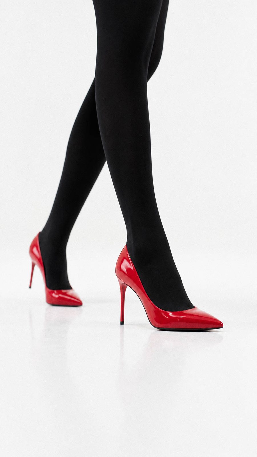 Red patent heels against black tights